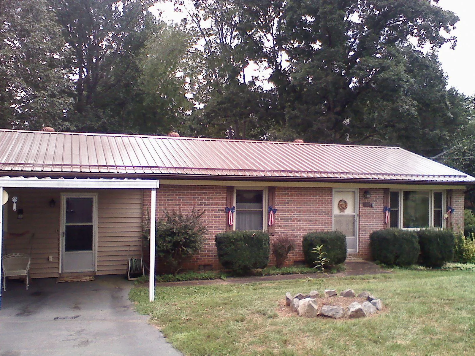 Bronze metal roof and carport on a brick ranch home — Roof Repair work by our crew in Zion Grove